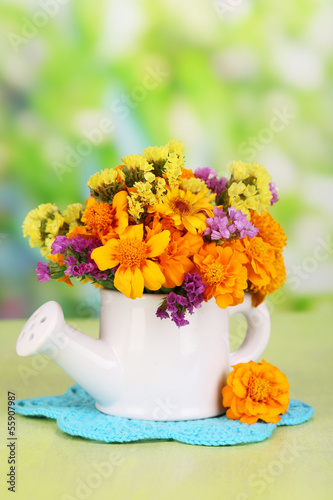 Photo: Bouquet of marigold flowers in watering can Bouquet of marigold flowers in watering can