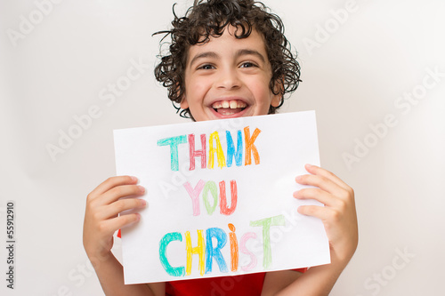 Photo: Hispanic child holding a religious sign Hispanic child holding a religious sign