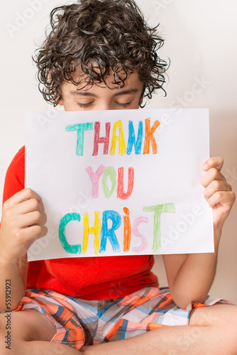 Photo: Hispanic child holding a religious sign Hispanic child holding a religious sign