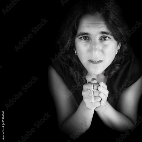 Photo: Black and white portrait of an hispanic woman praying Black and white portrait of an hispanic woman praying