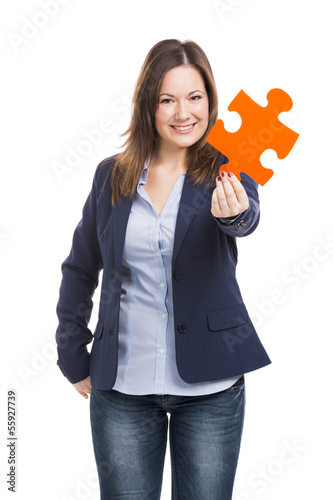 Photo: Business woman holding a puzzle piece Business woman holding a puzzle piece