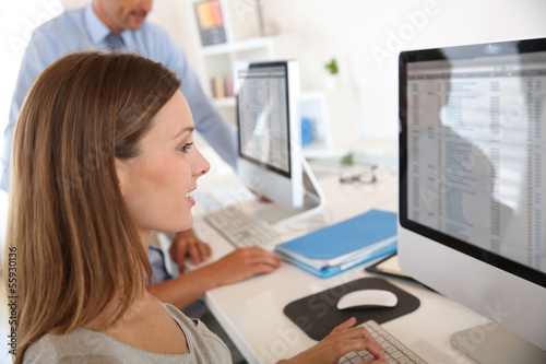 Photo: Woman in business training sitting in front of desktop Woman in business training sitting in front of desktop