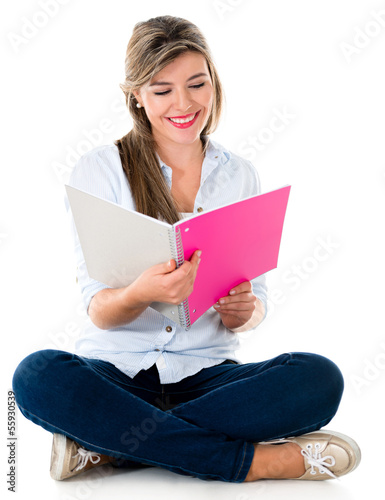 Photo: Student reading on her notebook Student reading on her notebook