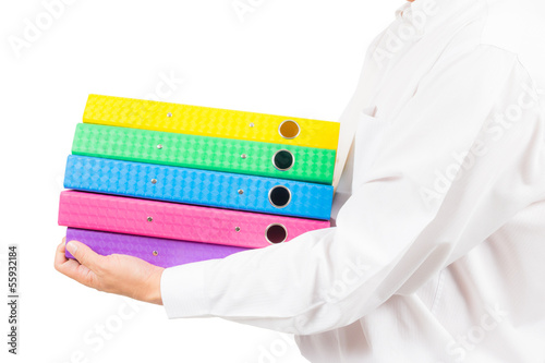Photo: business man holding stack of colorful folder business man holding stack of colorful folder