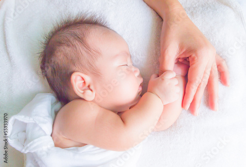 Photo: sleeping baby holding mom hand sleeping baby holding mom hand