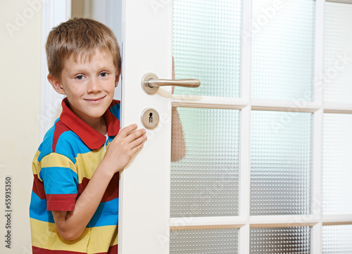 Photo: Boy opening door Boy opening door