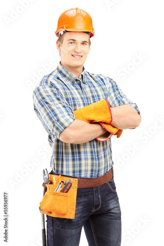 Photo: Confident and smiling manual worker with helmet posing Confident and smiling manual worker with helmet posing