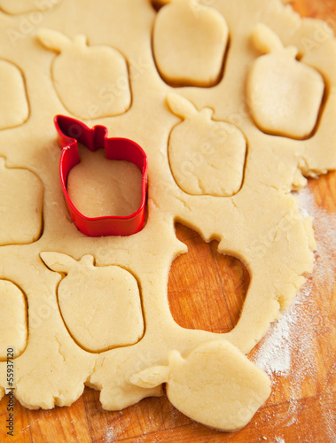 Photo: Apple shaped cookie cutter on raw cookie dough Apple shaped cookie cutter on raw cookie dough