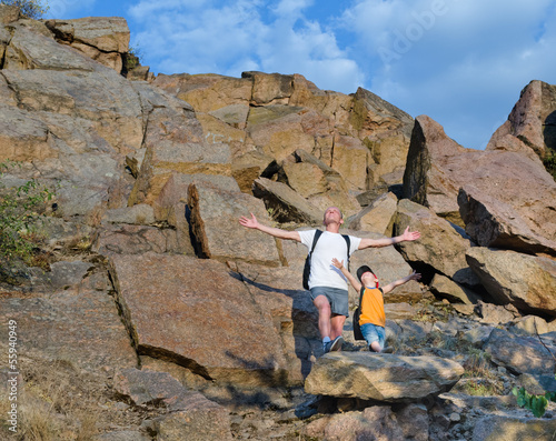 Photo: Father and son on a mountain ledge Father and son on a mountain ledge