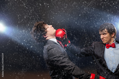 Photo: Two young businessman boxing Two young businessman boxing