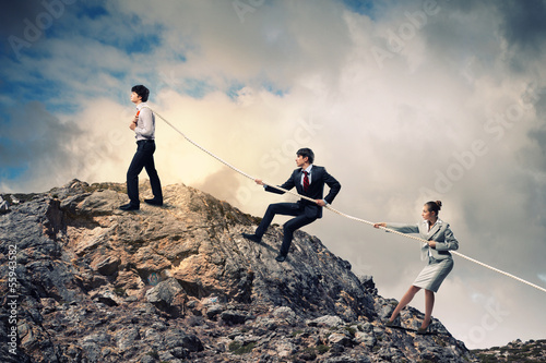 Photo: Three business people pulling rope Three business people pulling rope
