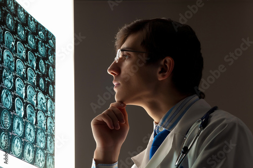 Photo: Man doctor looking at x-ray Man doctor looking at x-ray
