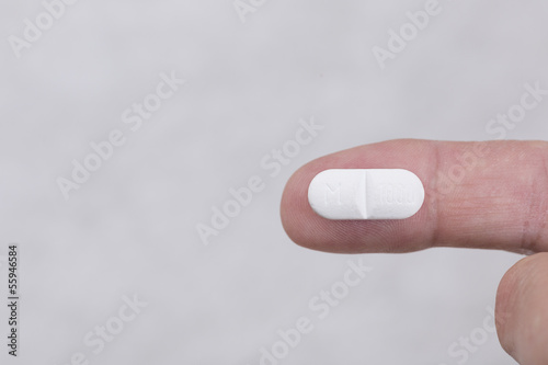 Photo: Fingers holding whitw medicament Fingers holding whitw medicament