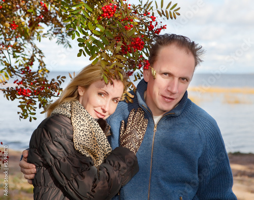 Photo: loving couple at a mountain ash bush loving couple at a mountain ash bush