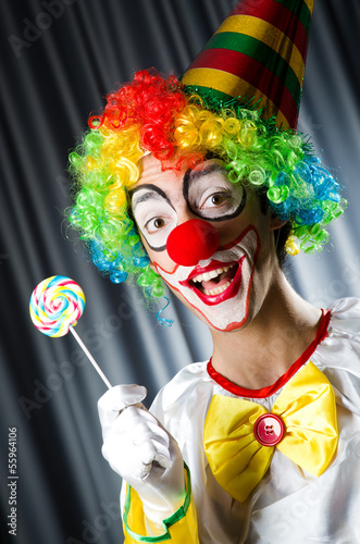 Photo: Clown with lollipops isolated on white Clown with lollipops isolated on white
