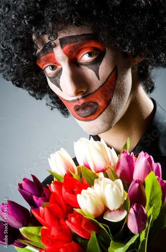 Photo: Sad clown with the flowers Sad clown with the flowers