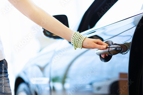Photo: Young lady at car salon Young lady at car salon