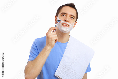 Photo: Young man at home shaving himself Young man at home shaving himself