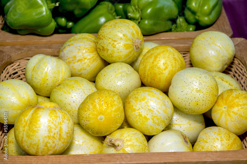 Photo: Round yellow vegetables in a basket at a market Round yellow vegetables in a basket at a market