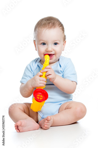 Photo: child boy playing musical toy isolated on white child boy playing musical toy isolated on white