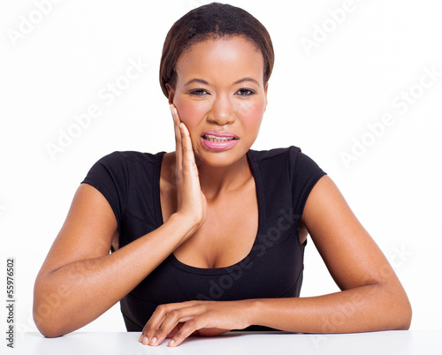Photo: young african woman suffering from toothache young african woman suffering from toothache
