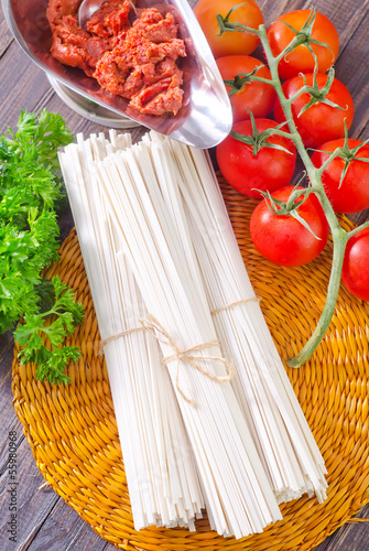 Photo: raw pasta and tomato and sauce raw pasta and tomato and sauce
