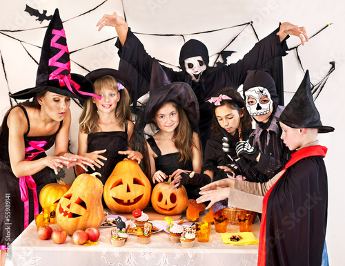 Photo: Halloween party with children holding trick or treat. Halloween party with children holding trick or treat.