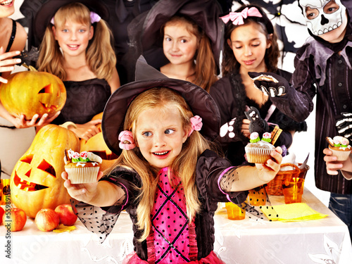 Photo: Halloween party with children holding trick or treat. Halloween party with children holding trick or treat.