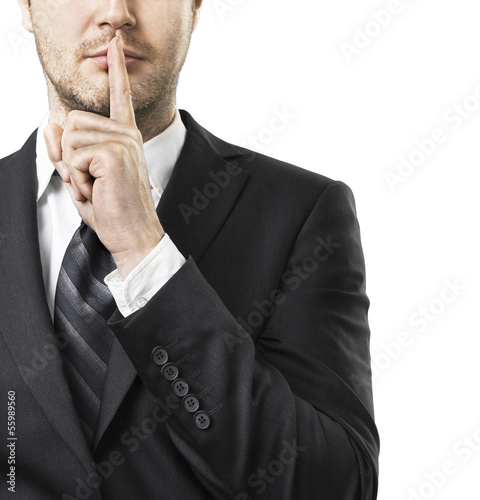 Photo: Businessman with finger on lips asking for silence Businessman with finger on lips asking for silence