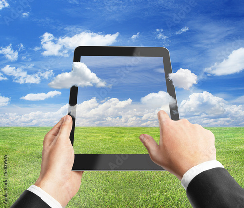 Photo: hand holding tablet hand holding tablet