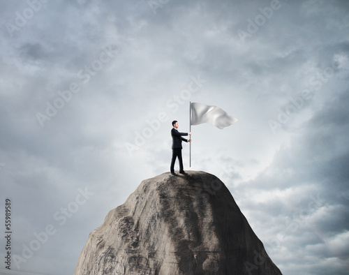 Photo: businessman with white flag businessman with white flag