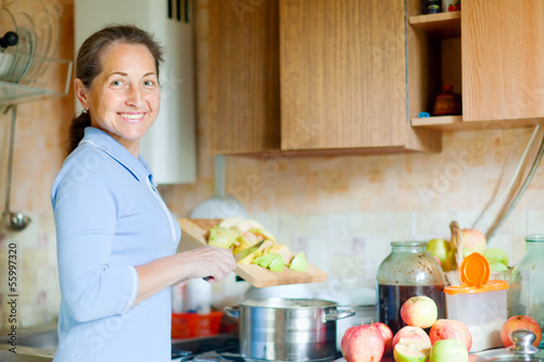 Photo: woman cooks applesauce jam woman cooks applesauce jam