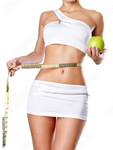 Photo: Healthy female body with apple and measuring tape. Healthy female body with apple and measuring tape.