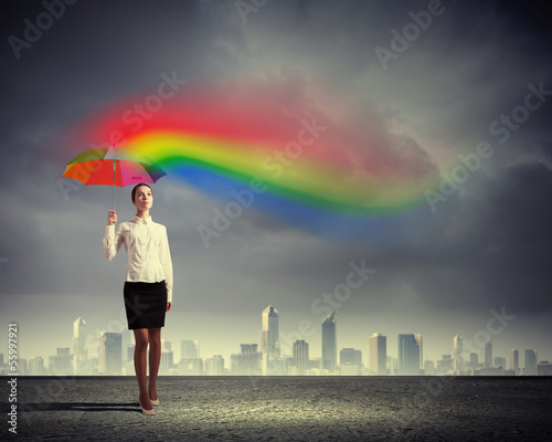 Photo: Young business woman holding an umbrella Young business woman holding an umbrella