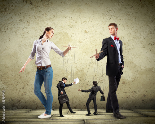 Photo: Businesspeople with marionettes Businesspeople with marionettes