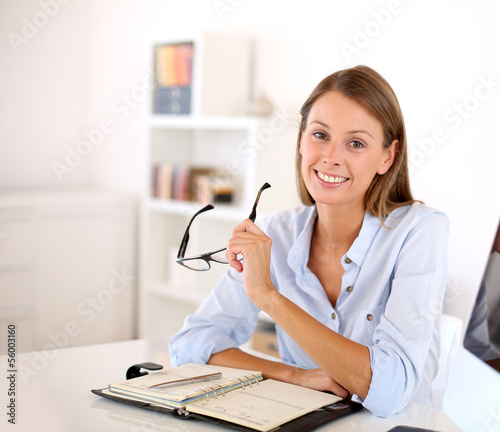 Photo: Portrait of smiling woman in office Portrait of smiling woman in office