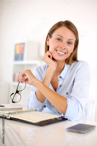 Photo: Portrait of smiling woman in office Portrait of smiling woman in office