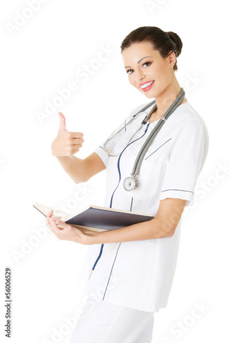 Photo: Attractive medicine student or doctor with book Attractive medicine student or doctor with book