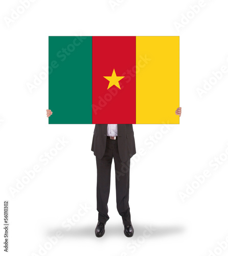 Photo: Businessman holding a big card, flag of Cameroon Businessman holding a big card, flag of Cameroon