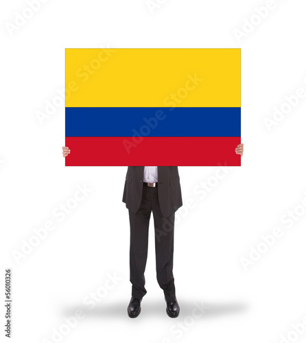 Photo: Businessman holding a big card, flag of Colombia Businessman holding a big card, flag of Colombia