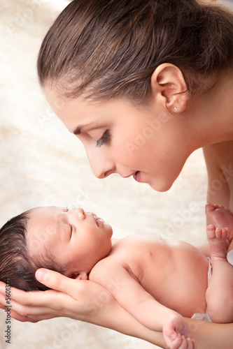 Photo: Yong happy mother holding her baby Yong happy mother holding her baby