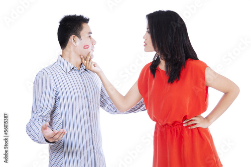 Photo: Jealous woman looking at her kissed man Jealous woman looking at her kissed man