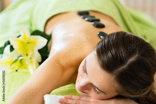 Photo: woman having wellness hot stone massage woman having wellness hot stone massage