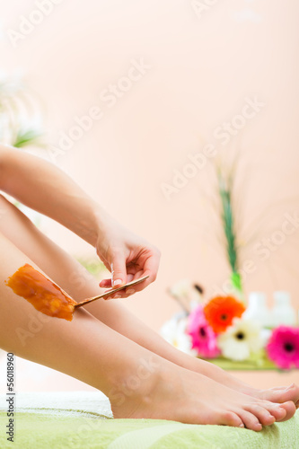 Photo: Woman in Spa getting leg waxed for hair removal Woman in Spa getting leg waxed for hair removal