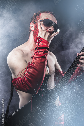 Photo: Rock star playing solo on guitar. heavy metal Rock star playing solo on guitar. heavy metal