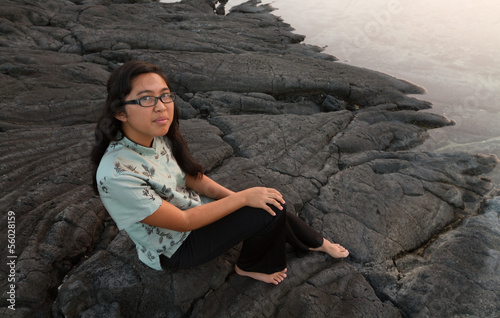 Photo: Barefoot Young Woman Looking Up at Water's Edge Barefoot Young Woman Looking Up at Water's Edge