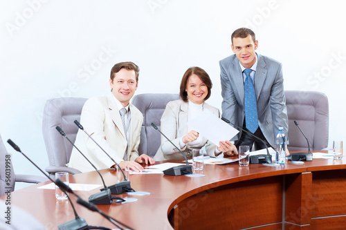 Photo: Three businesspeople at meeting Three businesspeople at meeting