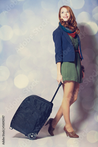 Photo: Redhead girl with a suitcase Redhead girl with a suitcase