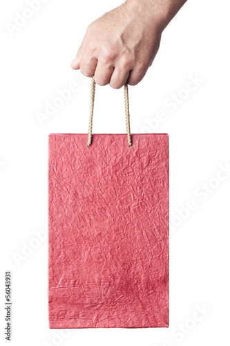 Photo: male hand holding red shopping bag isolated on white background male hand holding red shopping bag isolated on white background