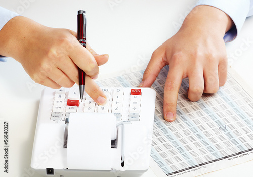 Photo: Hand with calculator. Hand with calculator.